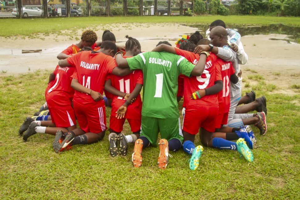 "Solidarity" female football team , kneeling for prayers before confronting "Unity" female soccer team in opening match
