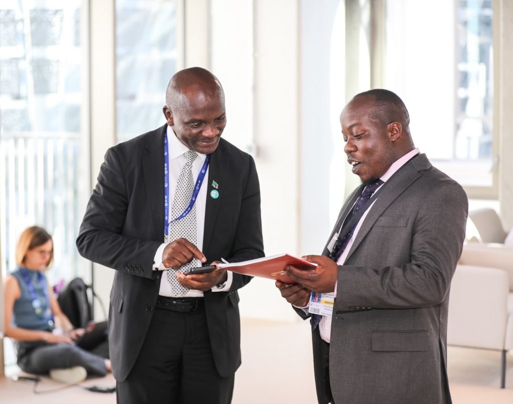 Amos Wemanya (Right) the Lead, Just Transitions at Power Shift Africa, presenting a copy the civil society statement on renewable energy targets for Africa to Ephraim Shitima, Chair, Africa Group of Negotiators