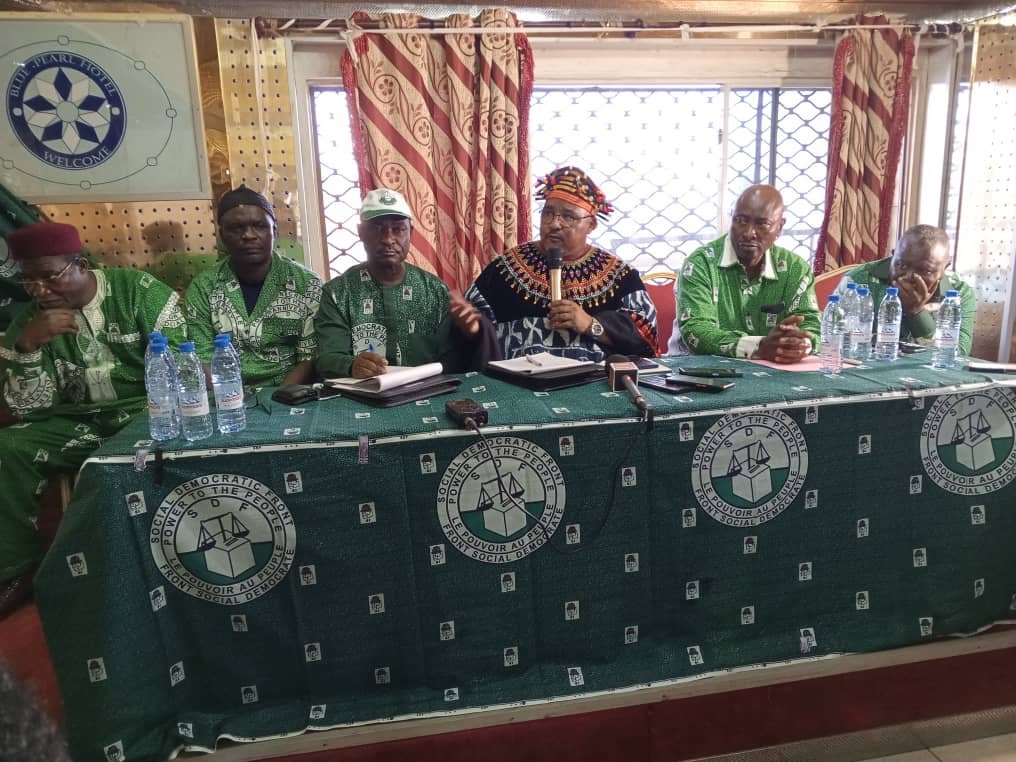 Joshua Osih (middle) speaking at a meeting with the press in Bamenda